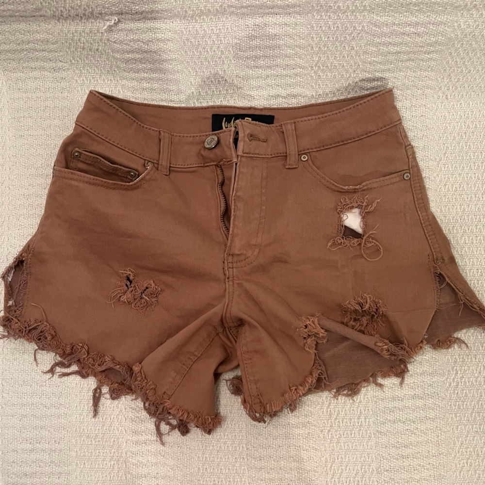 I’m selling Jean distressed shorts, they are a dark tan color in a size M